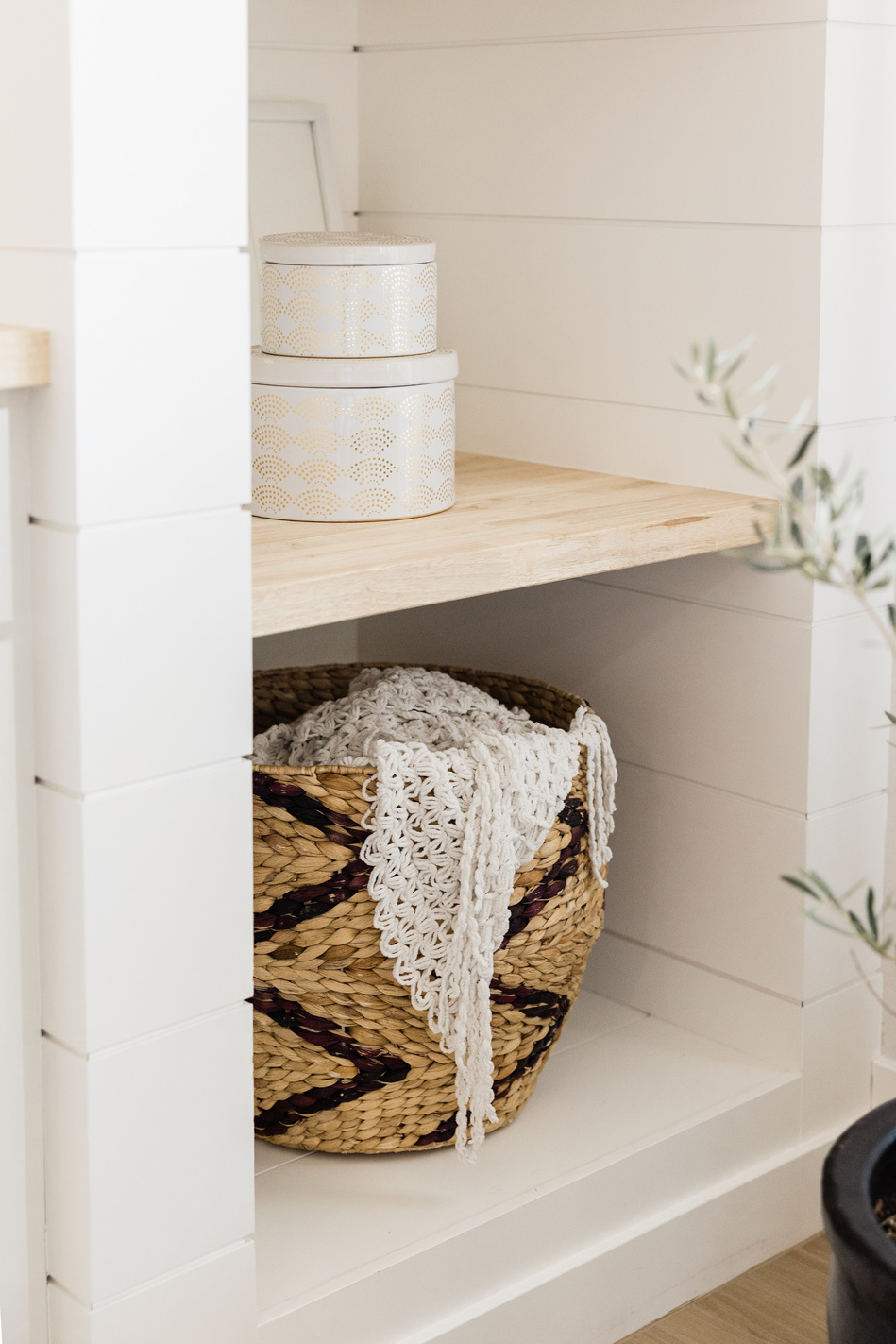 Wicker Basket and Tin Boxes in a Shelf